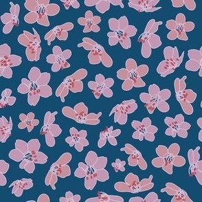 hand drawn pink and peach coloured cherry blossom seamless pattern on blue background.