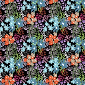 Happy, colorful, hand drawn floral clusters on black ground with sprigs and leaves.