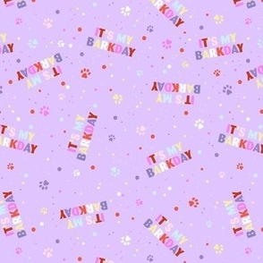 Colorful rainbow barkday design with confetti paws and happy birthday text tossed for dogs on bright lilac purple 