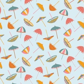 Tossed Beach Umbrellas in different shapes and colours – colourful parasols on a light blue background in a small scale