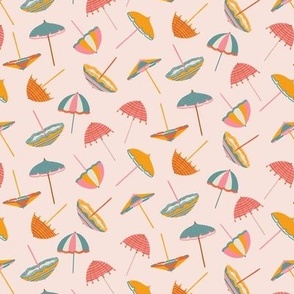 Tossed Beach Umbrellas in different shapes and colours – colourful parasols on a light pink background in a small scale