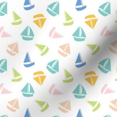 Small Colourful summer sailboats on white