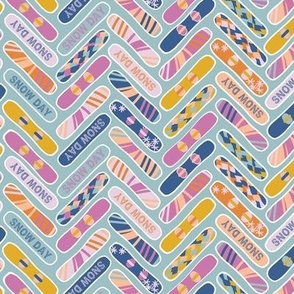 Colorful Snowboards in herringbone style in blue, pink and yellow
