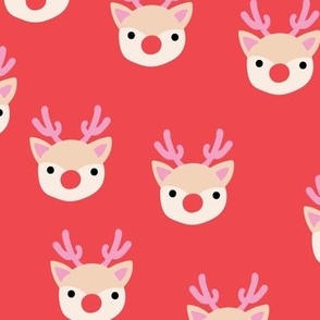 Little kawaii Christmas Rudolph reindeer with antlers and red nose on ruby red