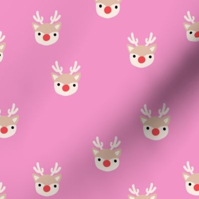 Little kawaii Christmas Rudolph reindeer with antlers and red nose on pink spaced 