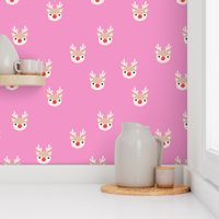 Little kawaii Christmas Rudolph reindeer with antlers and red nose on pink spaced 