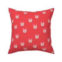 Little kawaii Christmas Rudolph reindeer with antlers and red nose on coral red