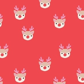 Little kawaii Christmas Rudolph reindeer with antlers and red nose on coral red