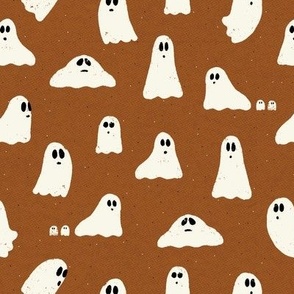 Spooky ghosts on Halloween night on a warm brown textured background - friendly ghost parade