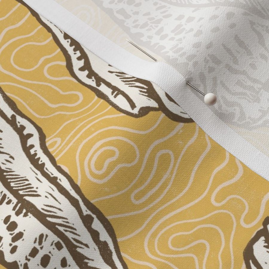 Large block printed seashells in retro colors of ecru off white and chocolate on mustard yellow