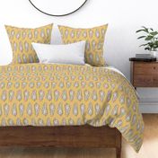 Large block printed seashells in retro colors of ecru off white and chocolate on mustard yellow