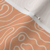 Large wavy watery textured block printed topographic lines in retro colors of coral on sandy cream