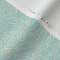 Small wavy watery textured block printed topographic lines in retro colors of light teal on sandy cream