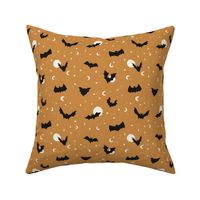 Flying bats on Halloween night with stars and moons in caramel yellow - small size