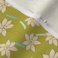 Yellow and orange hand drawn daffodils pattern on green background with blue confetti.
