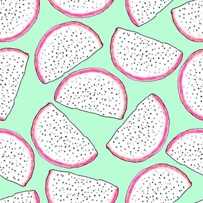 Dragonfruit slices on a light green background