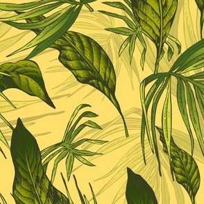 Green tropical leaves on yellow