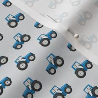 Rows of Blue Tractors on mist, pale grey - tiny scale