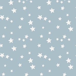 White stars tossed on Light Blue background