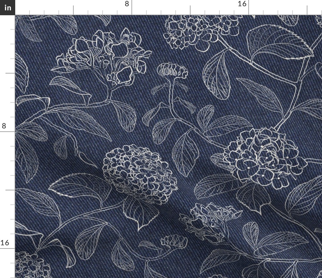 White trailing floral hydrangea on dark denim background