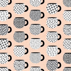 Mugs and Patterns- coffee and tea mugs decorated with black and white patterns  over peachy linen texture