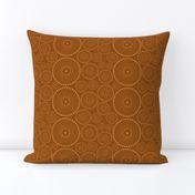 Sea floral circle ornament in yellow on copper brown background