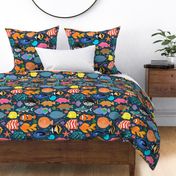 Deep Seas- colorful swimming fishes corals and shells design over dark navy blue texture, featuring clownfish, goldfish, neon tetra, angelfish, blue tang, zebra fish, puffer fish, butterflyfish, moorish idol, clown trigger fish, yellow tang zebrasoma