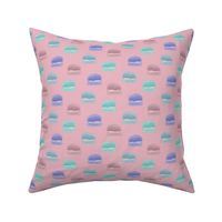 Hand painted macaroons in pink, blue, teal, and purple on a pink background  - medium
