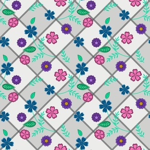 Blue, lilac, pink flowers on a gray checkered background.