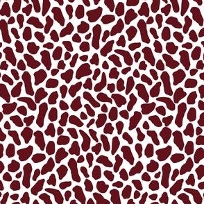 Small wild animal print, two color, maroon on white ground.