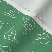 Colorful Aloho shaka surf - salty sea ocean greetings hang loose sign hand gesture white on jade green 