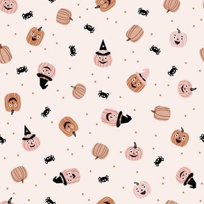 Cute Halloween pumpkins and spiders on cream