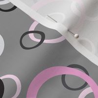 Festive Party Rings Tossed in Pink, White, Gray, and Black on Medium Gray