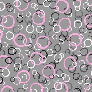 Festive Party Rings Tossed in Pink, White, Gray, and Black on Medium Gray