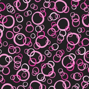 Festive Party Rings Tossed in Hot Pink, Blush Pink, and White on Black
