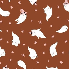 Cute White cat Ghosts in witch hats on chocolate brown