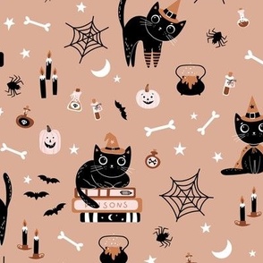 Cute black Halloween cats in witch hats on tan brown