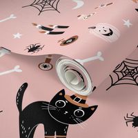 Cute black Halloween cats in witch hats on pink