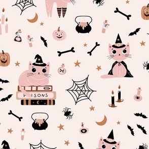 Cute Halloween cats in muted pink in witch hats on cream