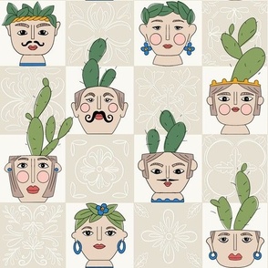 Checkered cactus plant pots with painted faces and cream tiles