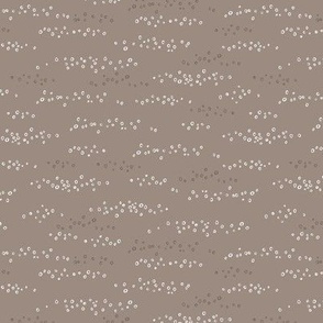 Hand drawn scattered white circles on taupe grey
