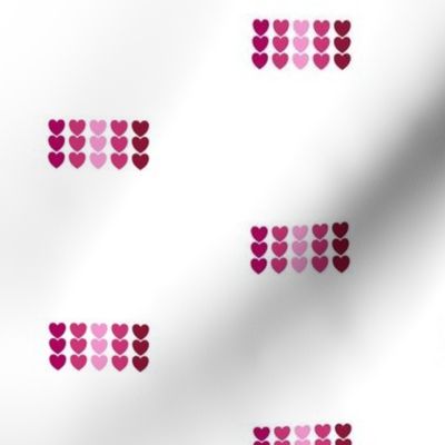 Ombre Pink Colored Hearts in Rows on White Background