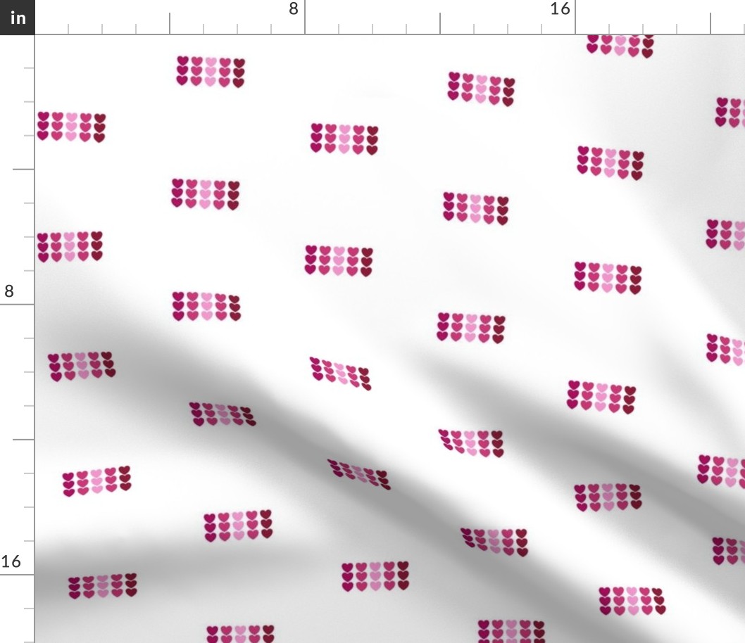 Ombre Pink Colored Hearts in Rows on White Background