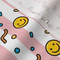 Pop art happy emoji in baby pink stripes background