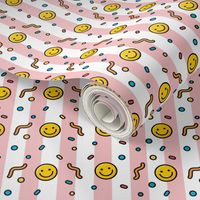 Pop art happy emoji in baby pink stripes background