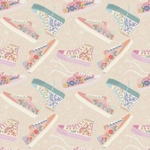 Scattered sneakers on a tan floral background