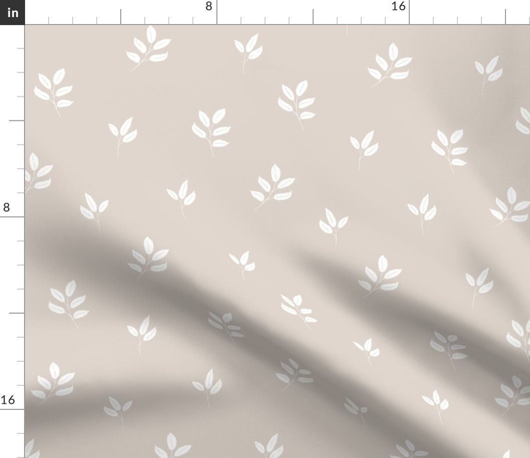 white ash leaves on cappuccino background, neutral fabric
