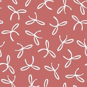 Freehand bows in polka dot style design - white on redwood red background