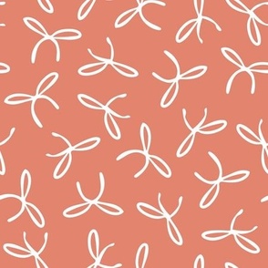 Freehand bows in polka dot style design - white on coral pink background