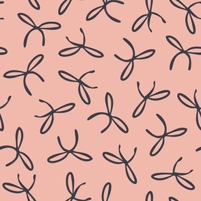 Freehand bows in polka dot style design - black on salmon pink background